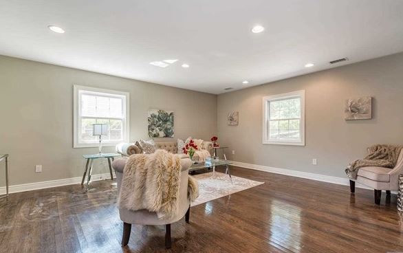 Before and after real estate photo enhancement of a living room with brighter lighting, richer floors, and refreshed styling — before