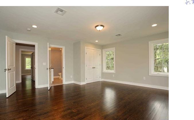 Before — Before and after virtual staging of a primary bedroom with upholstered bed, nightstands, dresser, artwork, and area rug