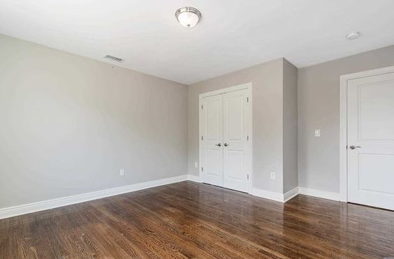 Before — Before and after virtual staging of a guest bedroom with queen bed, nightstands, and artwork
